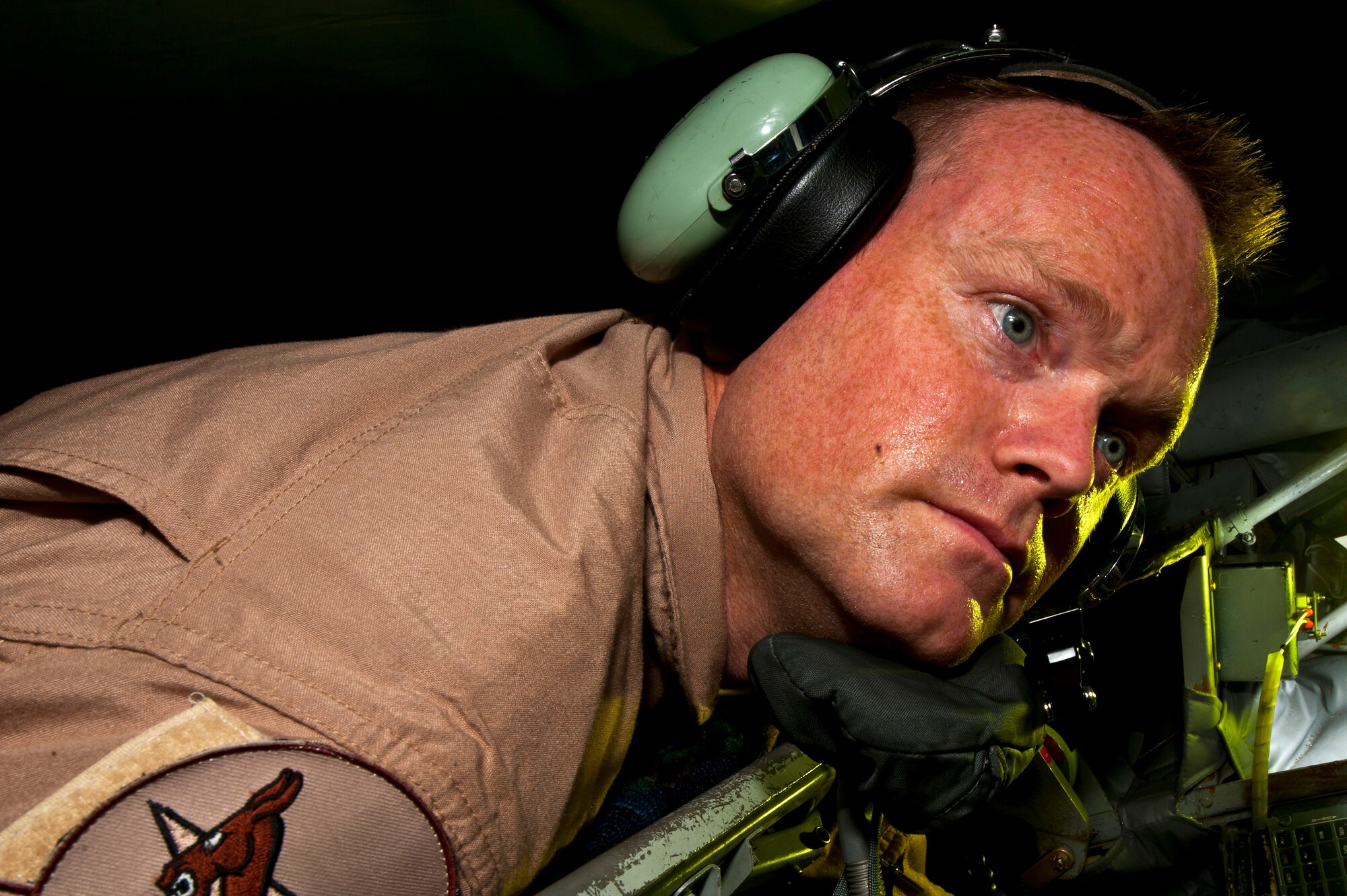Senior Master Sgt. Keith Werner looks out the back of a KC-135 Stratotanker at the Transit Center at Manas, Kyrgyzstan, Aug. 31, 2012.  While taking on the initial fuel load, the stricken pilot told the crew he had engaged with troops on the ground and requested the boom operators look his jet over for any possible battle damage. Werner and the observer boom, together, checked the fighter for damage.  Werner is a 22 EARS boom operator deployed out of the 137th Air Refueling Wing, Oklahoma Air National Guard and is a native of Oklahoma City. (U.S. Air Force photo/Senior Airman Brett Clashman)