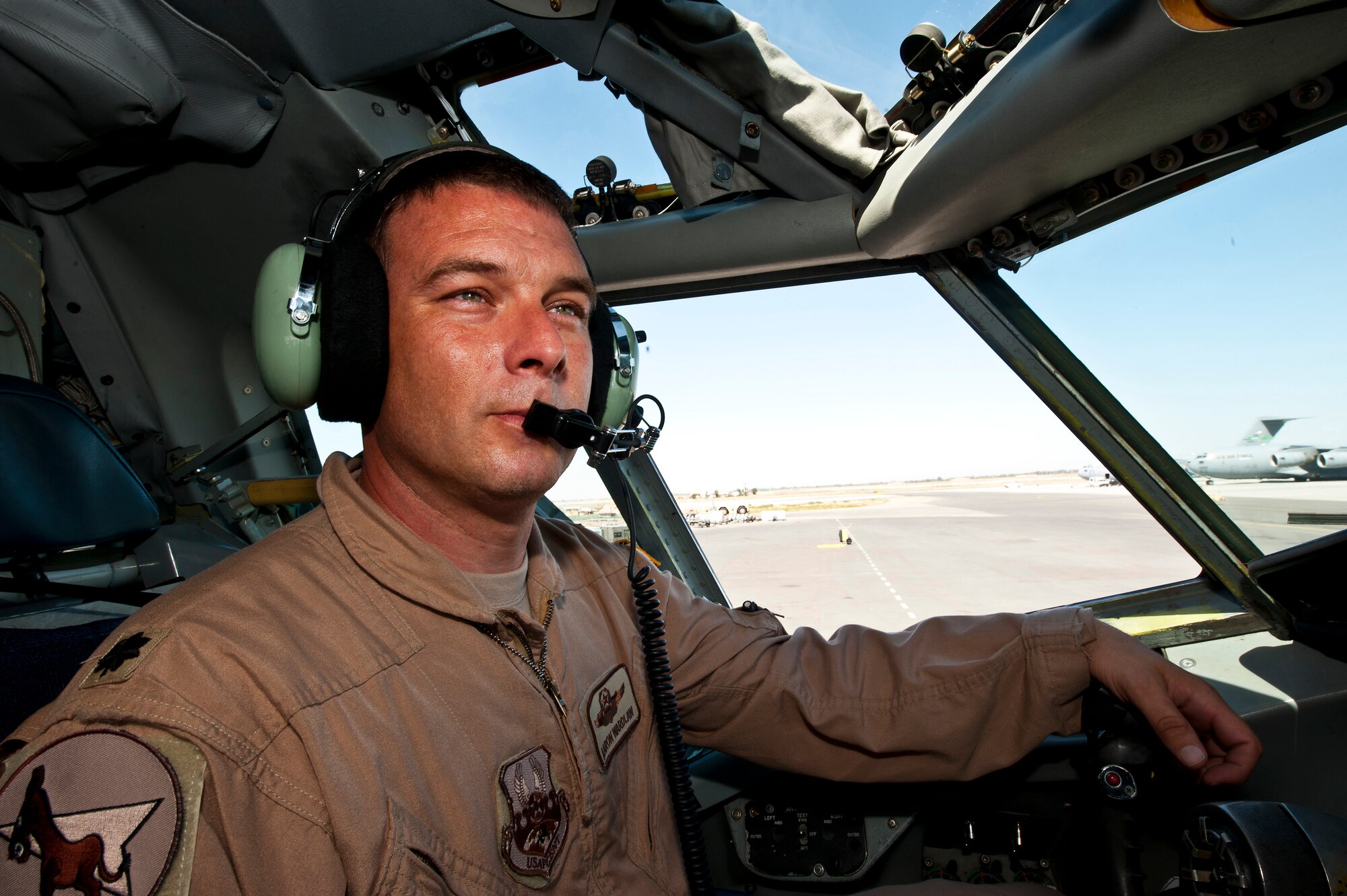 Lt. Col. Aaron Wardlaw looks out a KC-135 Stratotanker at the Transit Center of Manas, Kyrgyzstan, Aug. 31, 2012. "It's all about taking care of your own," Wardlaw said when speaking about assisting a stricken fighter during a recent mission. "While we may operate different platforms , ultimately he's a fellow Airman who needed our help on a bad day. Wardlaw is a 22 EARS aircraft commander deployed out of the 137th Air Refueling Wing, Oklahoma Air National Guard, and a native of Stillwater, Okla. (U.S. Air Force photo/Senior Airman Brett Clashman)