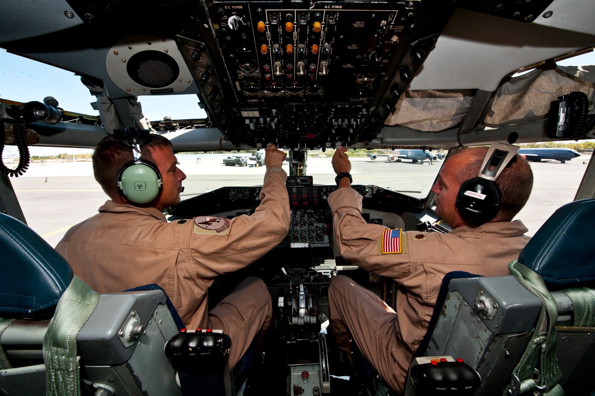 Left, Lt. Col. Aaron Wardlaw and Maj. Jody Griffin conduct pre-flight checks in a KC-135 Stratotanker at the Transit Center at Manas, Kyrgyzstan, Aug. 31, 2012. The 22nd Expeditionary Air Refueling Squadron KC-135 crew assisted a stricken fighter aircraft by guiding the jet through a series of specific maneuvers to reset the on-board flight computers and allowing the pilot to regain effective communications and navigational instruments. Wardlaw is a 22 EARS aircraft commander deployed out of the 137th Air Refueling Wing, Oklahoma Air National Guard, and a native of Stillwater, Okla. Griffin is a KC-135 pilot deployed out of the 137 ARW and a native of Greenville, Miss. (U.S. Air Force photo/Senior Airman Brett Clashman)