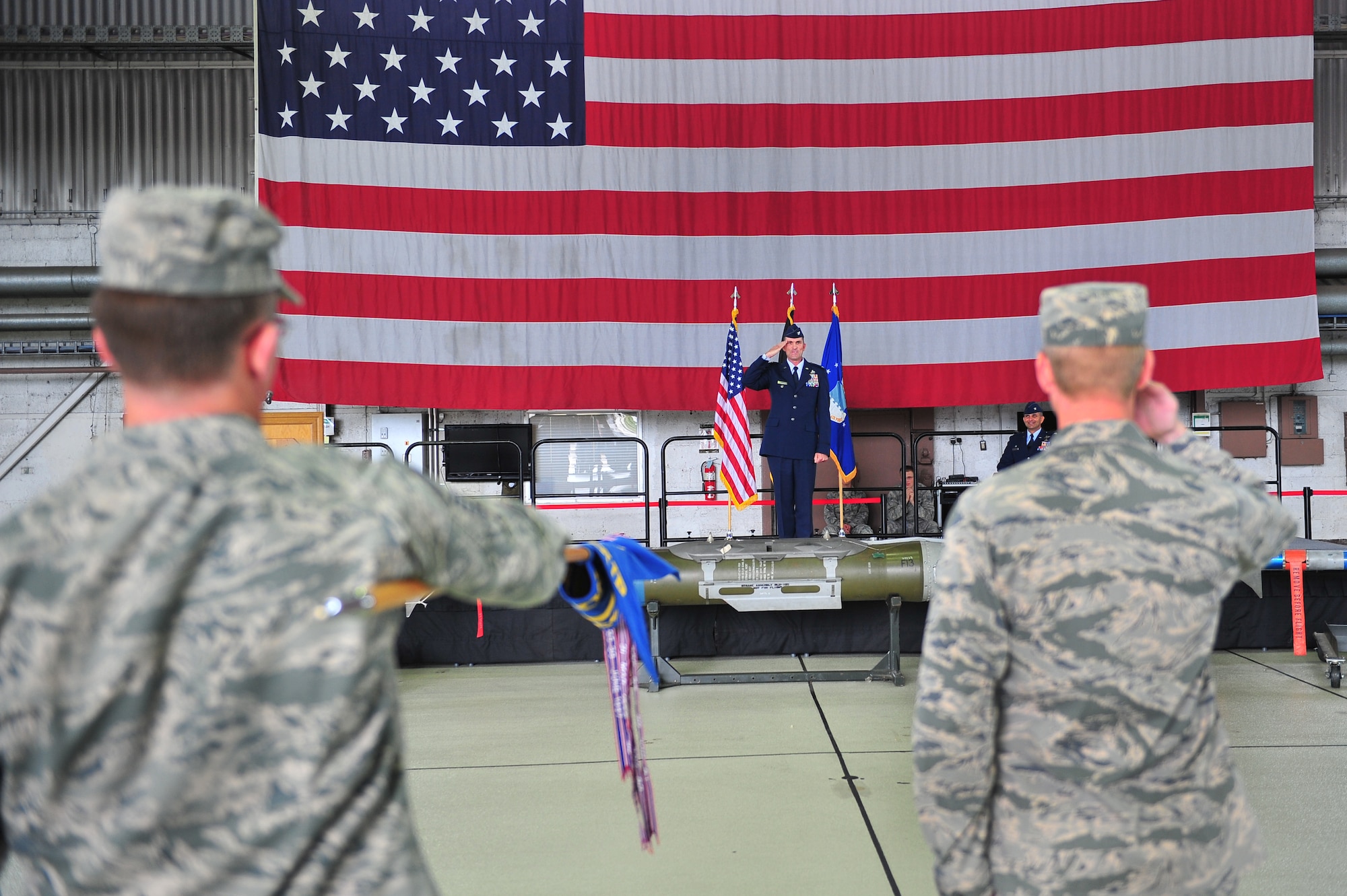 SPANGDAHLEM AIR BASE, Germany – Col. James Humes, center, 52nd Maintenance Group commander, salutes his group for the first time during Humes’s assumption of command ceremony inside Hangar 1 here Aug. 28. The ceremony honors the incoming commander with attendance from the group’s Airmen and family members. (U.S. Air Force photo by Airman 1st Class Dillon Davis/Released)