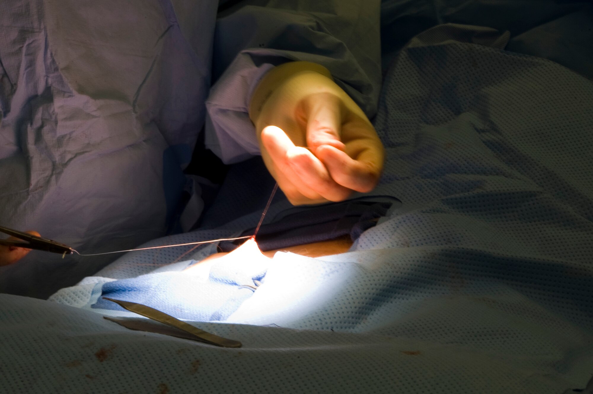 U.S. Air Force Major Thomas Ziolkowski, 379th Expeditionary Medical Group general surgeon, closes a surgical wound after performing a hernia surgery in Southwest Asia, August 17, 2012. The 379th surgical team provides surgical support for the entire area of responsibility. Ziolkowski is deployed from Joint Base Andrews, Md.  (U.S. Air Force photo/Staff Sgt. Sheila deVera)