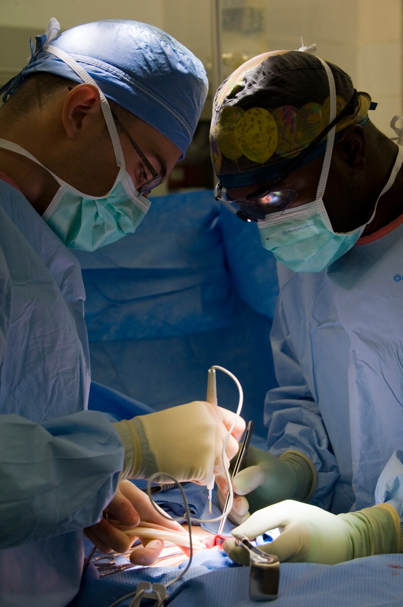 U.S. Air Force Major Noris Jackson assists General Surgeon Maj. Thomas Ziolkowski with a hernia surgery in Southwest Asia, August 17, 2012. The 379th surgical team provides surgical support for the entire area of responsibility. Jackson and Ziolkowski are both assigned to the 379th Expeditionary Medical Group. (U. S. Air Force photo/Staff Sgt. Sheila deVera)