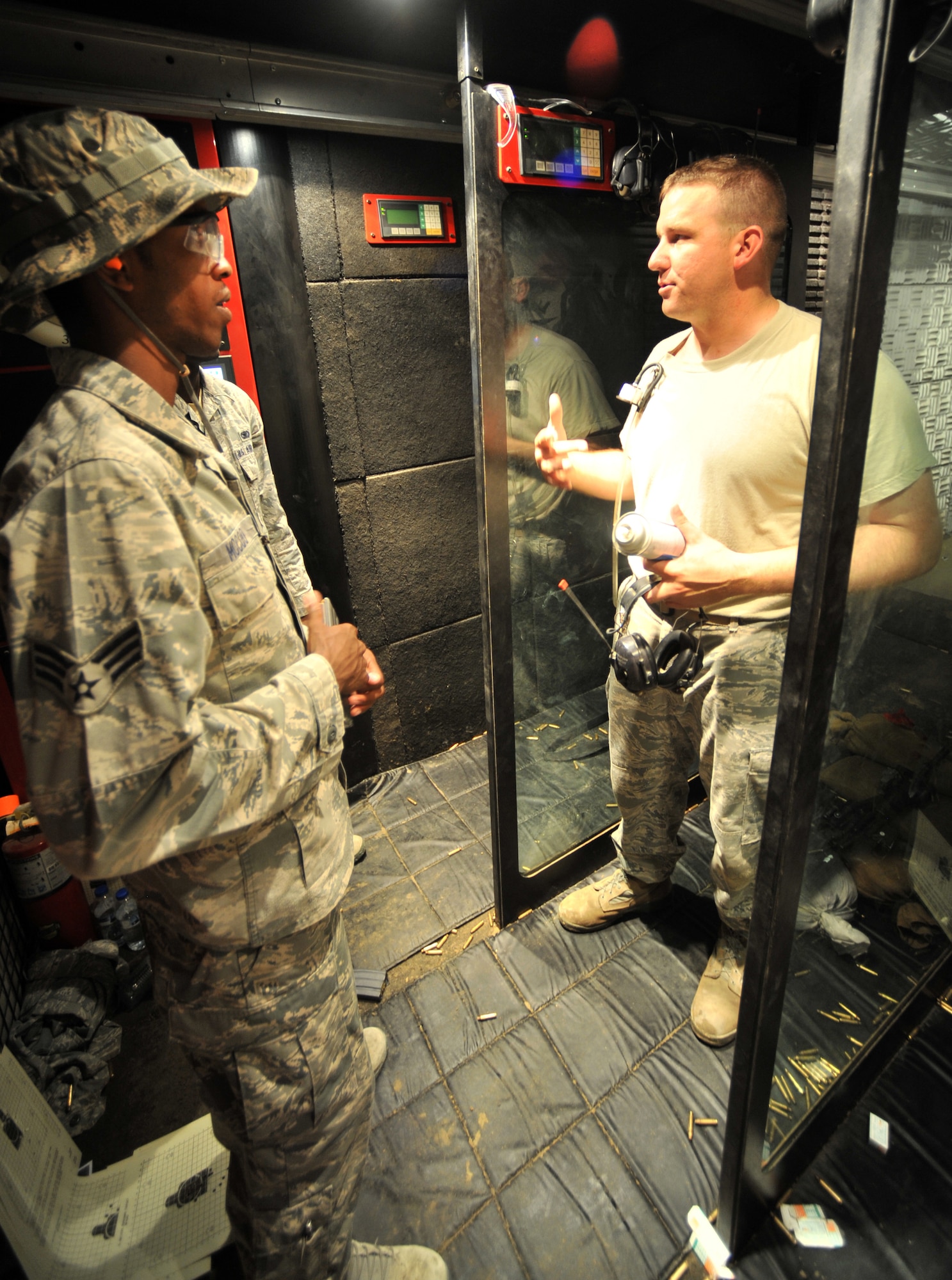 SOUTHWEST ASIA - U.S. Air Force Staff Sgt. Richard Mulford, 380th Expeditionary Security Forces Squadron Combat Arms Training and Maintenance NCO in charge, right, briefs Senior Airman Andre McCoo, 380th ESFS member, and another Airman on rules of the mobile firing range before they zero their weapons Aug. 24, 2012. Proper aim is achieved when a weapon is "zeroed," meaning its sights are set specifically to the shooter so the shooter can actively and precisely engage a target. (U.S. Air Force photo/Senior Airman Jared Elliott)