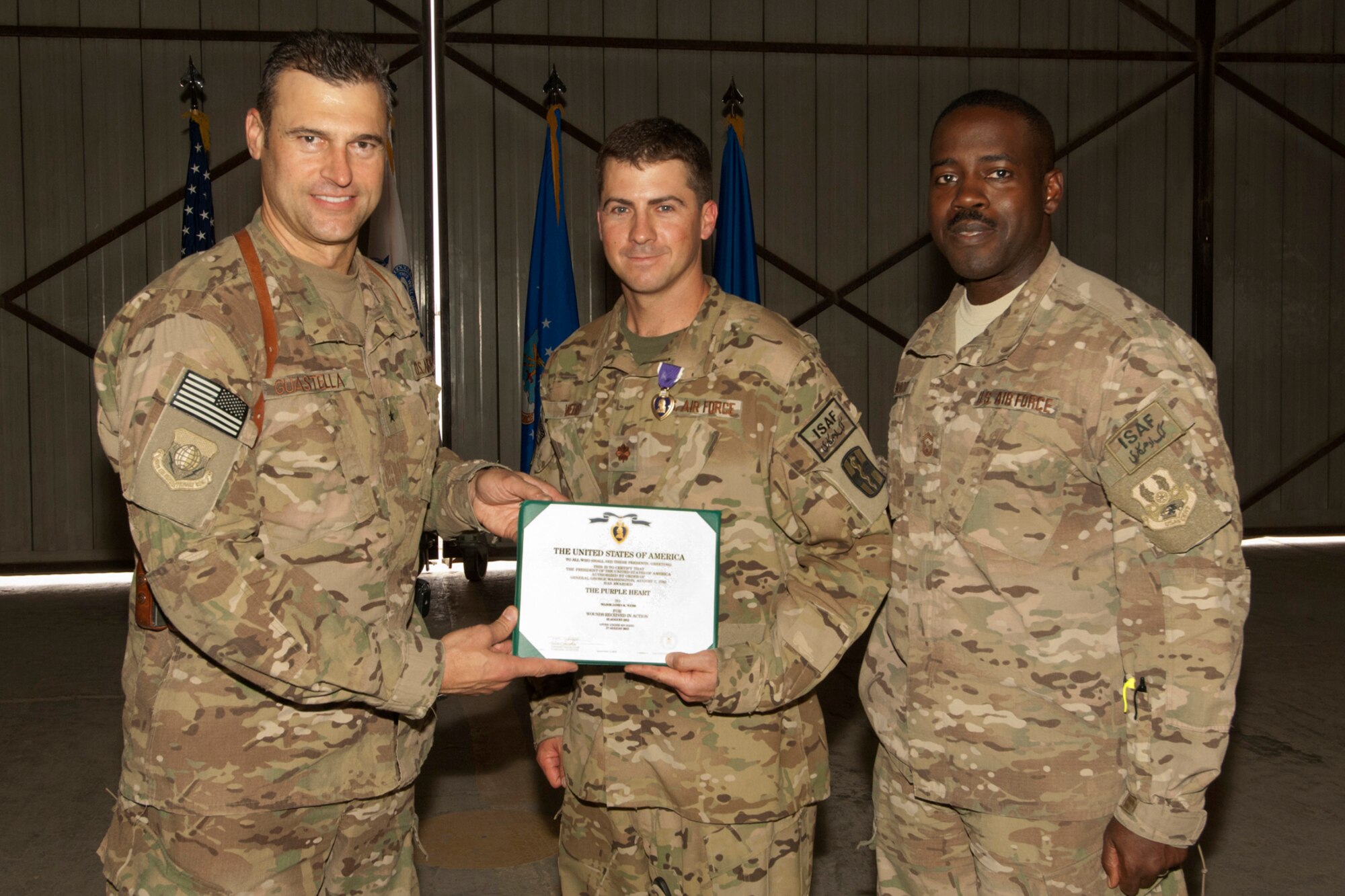 Brig. Gen. Joseph Guastella, Commander 455th Air Expeditionary Wing, presents a Purple Heart to Maj. James Webb, a Critical Care Nurse assigned to the U.S. Army’s 966th Forward Surgical Team, Task Force-Medical Alpha, at Bagram Airfield, Afghanistan, Aug. 28, 2012. Webb was serving as part of the medical evacuation crew in the central Ghazni Province of Afghanistan when he was shot by an enemy AK-47 while loading a patient aboard his helicopter. (U.S. Air Force photo/SSgt Jeff Nevison)