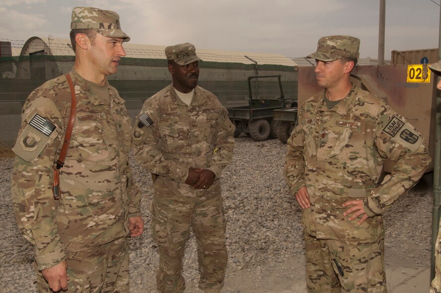 Brig. Gen. Joseph Guastella, 455th Air Expeditionary Wing commander, and 455th AEW Command Chief, Chief Master Sgt. Marcus Snoddy, speak with Maj. James Webb, a Critical Care Nurse assigned to the U.S. Army’s 966th Forward Surgical Team, Task Force-Medical Alpha, prior to Webb’s Purple Heart presentation at Bagram Airfield, Afghanistan, Aug. 28, 2012. Webb was serving as part of the medical evacuation crew in the central Ghazni Province of Afghanistan when he was shot by an enemy AK-47 while loading a patient aboard his helicopter. (U.S. Air Force photo/Staff Sgt. Jeff Nevison) 

