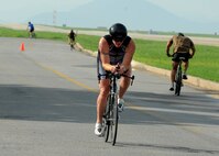 William Goins, 8th Medical Operations Squadron and Wolf Pack Exercise Physiologist , passes other bicyclists during a triathlon on  Kunsan Air Base, Republic of Korea, Aug. 25. This was the second triathlon this year and featured a 300-meter run, 25-kilometer bike ride and 5-kilometer run. (U.S. Air Force photo/Staff Sgt. Jonathan Fowler)