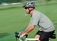 Master Sgt. Christopher Miller, 8th Fighter Wing, begins the biking portion of a triathlon on Kunsan Air Base, Republic of Korea, Aug. 25. This was the second triathlon this year and featured a 300-meter run, 25-kilometer bike ride and 5-kilometer run. (U.S. Air Force photo/Staff Sgt. Jonathan Fowler)