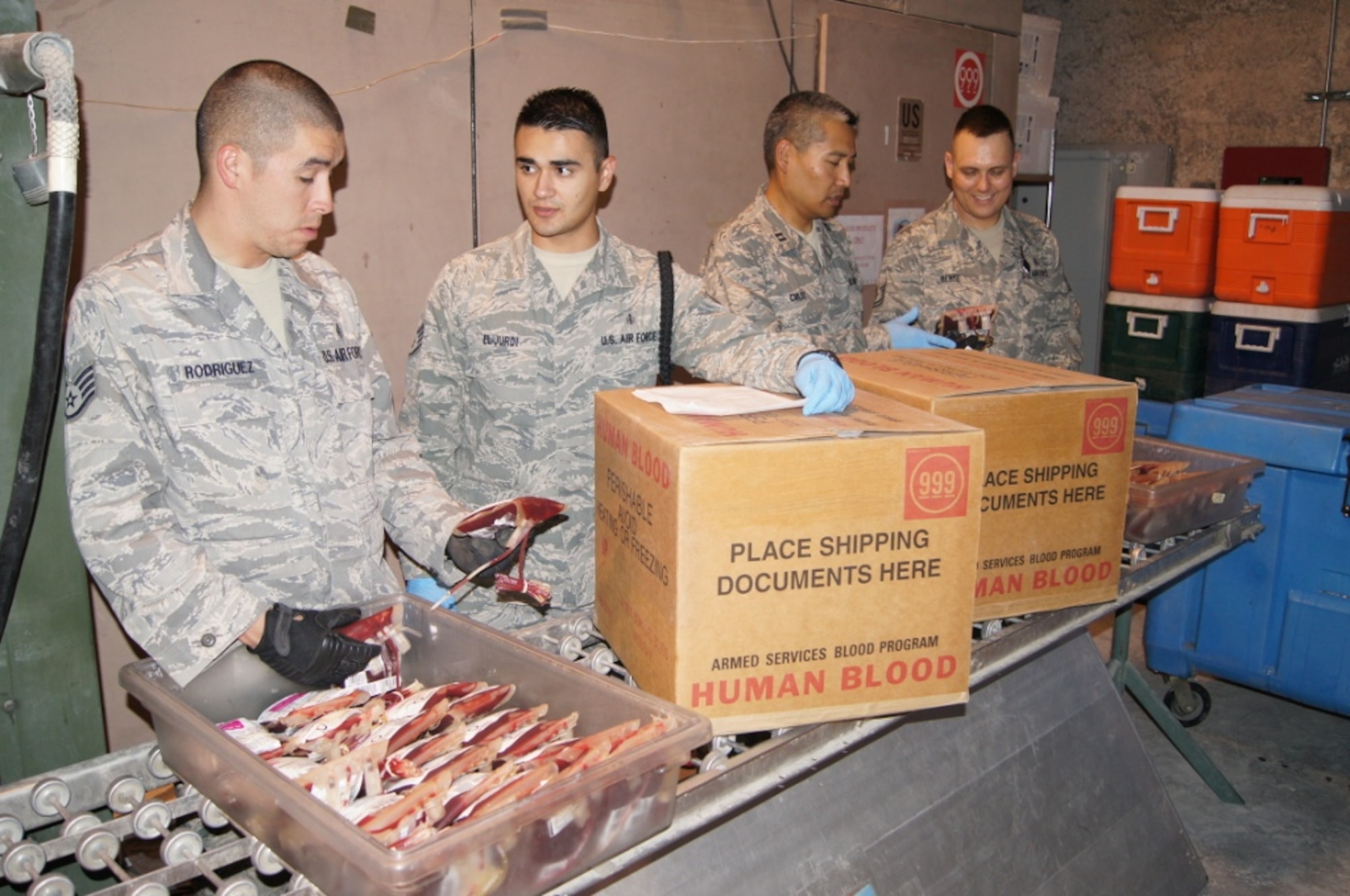 Members of the 379th Blood Transshipment Center (left to right) Staff Sgt. Jorge Rodriguez, Staff Sgt. Rashad El-Jurdi, Capt. Brian Cruz and Tech. Sgt. Joshua Bense sort through and process every unit of blood distributed throughout the area of responsibility. The BTC is the sole supplier of blood products and dry ice in the in the AOR and is responsible for maintaining blood supplies for two blood shipment depots and 32 forward operating bases. (U.S. Air Force photo/Chief Master Sgt. Lawrence Blake)