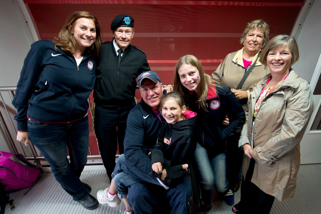 Retired U.S. Army 1st Sgt Class Josh Olson and his family pose for a photo with U.S. Army Gen. Martin E. Dempsey, chairman of the Joint Chiefs of Staff, in London, Aug. 30, 2012. 
