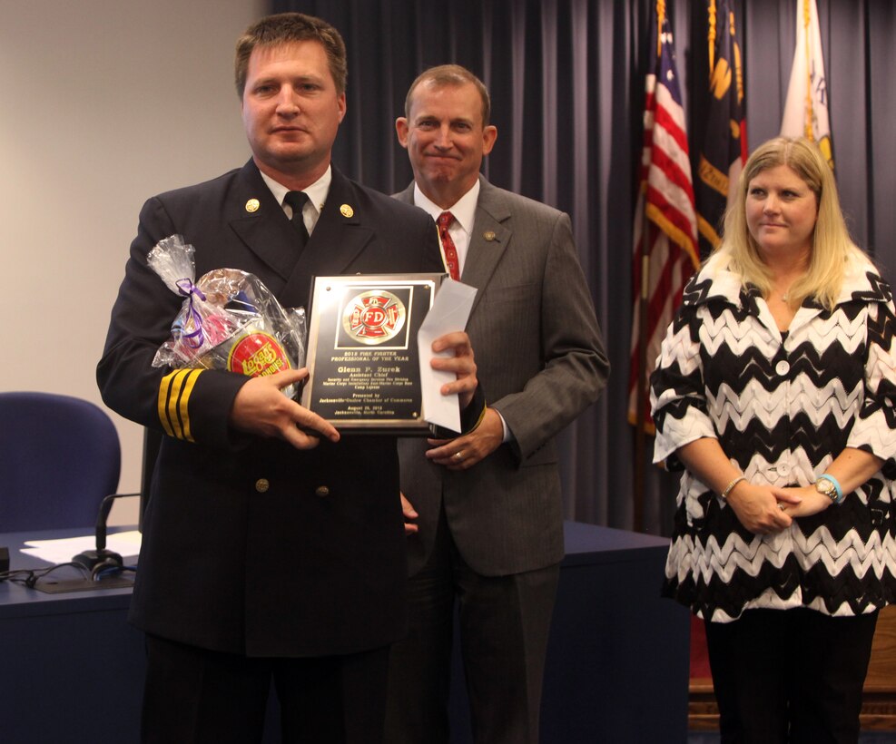 Glenn Zurek, assistant chief of training for the fire department for Marine Corps Installations East – Marine Corps Base Camp Lejeune and winner of the Firefighter Professional of the Year at the 2012 Onslow County Public Safety Awards Ceremony at City Hall in Jacksonville, N.C., poses for a picture with his plaque Aug. 29. Zurek is currently the accreditation manager for his division and the acting fire prevention chief.