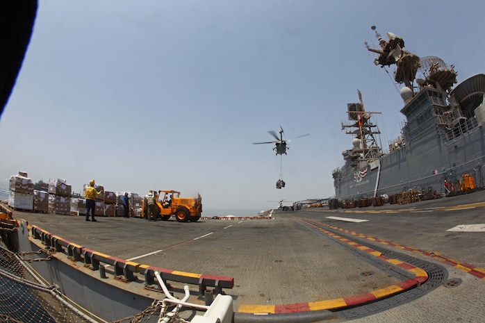 A helicopter from the USNS Rappahannock delivers food and supplies on the flight deck of USS Iwo Jima during a replenishment at sea detail Aug. 29, 2012. During the RAS the USS Iwo Jima took on fuel, fresh fruits and vegetables, supplies and mail to sustain the ship through the next few weeks. The 24th MEU is deployed with the Iwo Jima Amphibious Ready Group as a theater reserve force for U.S. Central Command and is providing support for maritime security operations and theater security cooperation efforts in the U.S. Navy's 5th Fleet area of responsibility.