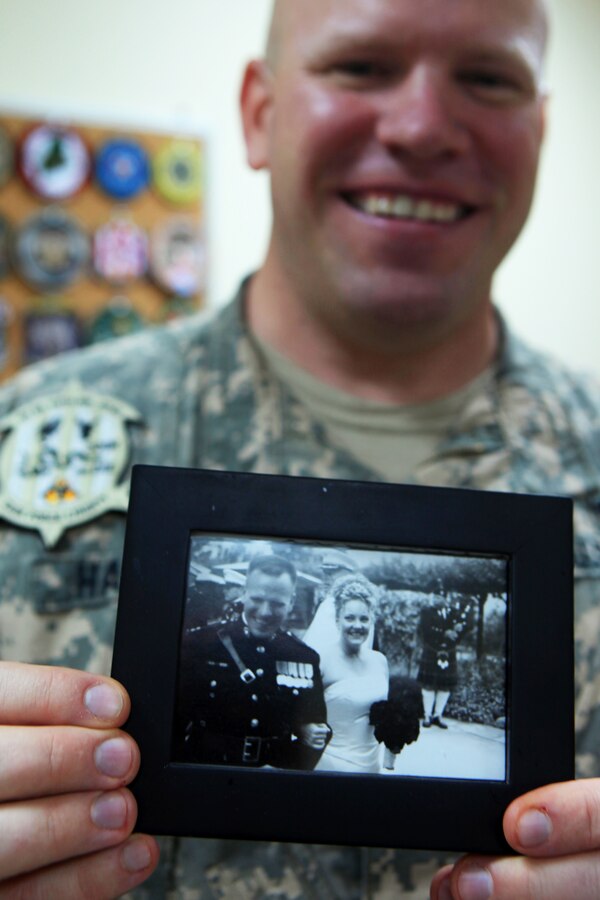 Former Marine and now U.S. Army chaplain, Capt. David Harvey, proudly displays an 11-year anniversary photograph in Camp Buehring, Kuwait, Aug. 3, 2012, of he and his wife with Harvey showcasing his Marine Dress Blues. Harvey volunteered to provide chaplain services to Marine Medium Tiltrotor Squadron (VMM) 261 (Reinforced), 24th Marine Expeditionary Unit, while they conducted sustainment training in Kuwait. The 24th MEU is deployed with the Iwo Jima Amphibious Ready Group as a U.S. Central Command theater reserve force providing support for maritime security operations and theater security cooperation efforts in the U.S. 5th Fleet area of responsibility.