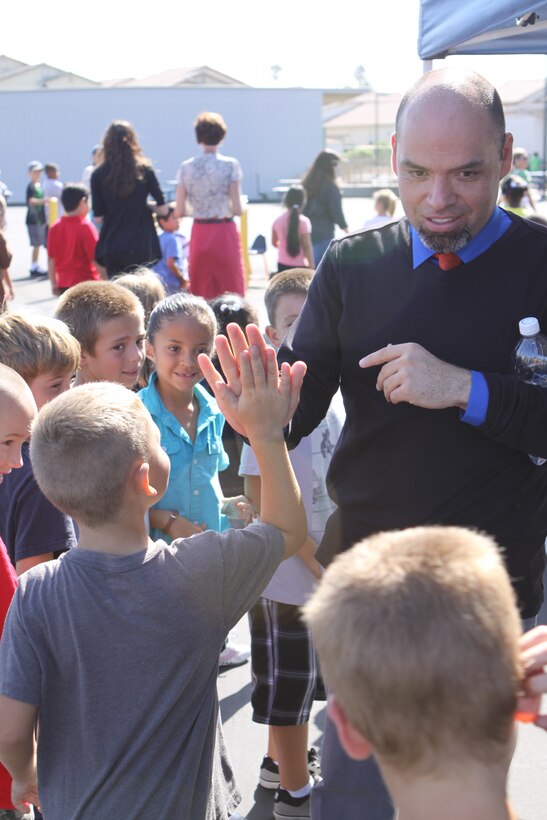 Fausto Barragan, the principal of North Terrace Elementary here, high-fives students at the school’s grand re-opening ceremony on their new and improved campus, Aug. 31. In addition to celebrating the renovated school’s re-opening, students and faculty also commemorated their new designation of California Distinguished School for 2012. North Terrace re-opened its doors after being closed for renovations for more than a year. Representatives from Oceanside Unified School District, as well as Col. David Terando, chief of staff for Marine Corps Installations-West, Marine Corps Base Camp Pendleton, were on hand to celebrate with the children and faculty.
