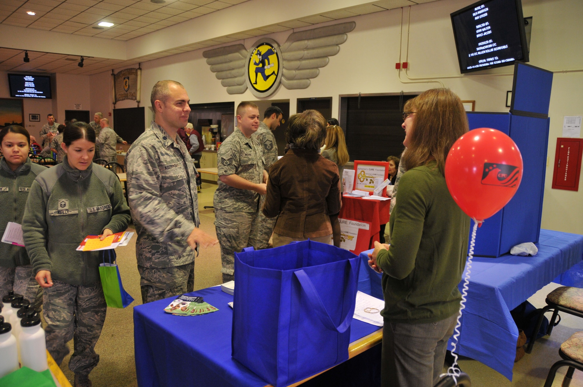 Members of the Connecticut Air National Guard check out the displays and information booths for charities during the annual Combined Federal Campaign kick-off event hosted by the 103rd Airlift Wing at Bradley Air National Guard Base, East Granby, Conn., Nov. 14, 2012. (U.S. Air Force photo by Senior Airman Emmanuel Santiago)