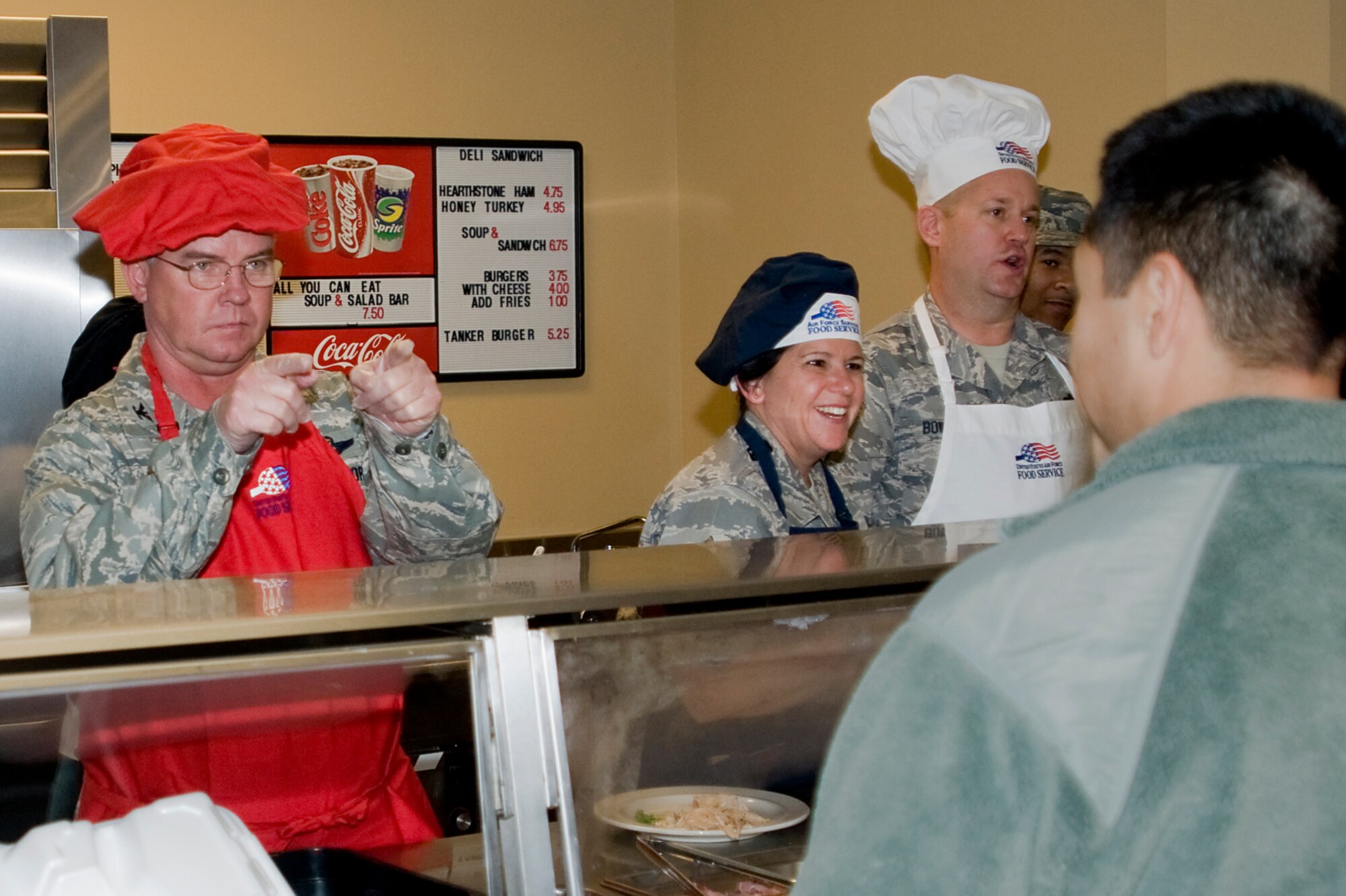 GRISSOM AIR RESERVE BASE, Ind.-- Col. Don Buckley, 434th Air Refueling Wing commander focuses in on his next customer during a holiday meal. Buckley, along with Command Chief Master Sgt. Karen Perkins, 434th ARW command chief, and Chief Master Sgt. Michael Bowden, 434th Civil Engineer Squadron civil engineer manager, rolled up their sleeves to serve a holiday meal and greet Airmen during a recent Unit Training Assembly. (U.S. Air Force photo/Senior Airman Jami K. Lancette)