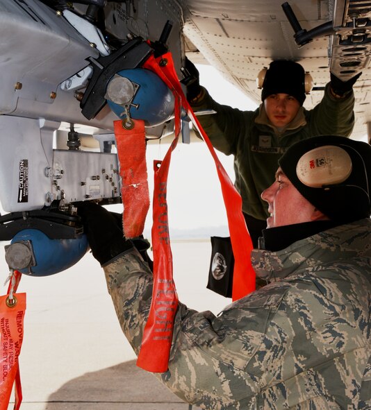 Tech. Sgt. Michael, foreground, checks the BDU-33 practice bombs that Airman 1st Class Oscar A. Marroquin loaded onto an A-10C Thunderbolt II at Warfield Air National Guard base in Baltimore, Md. Both are weapon loaders with the 175th Aircraft Maintenance Squadron and were uploading munitions for a training sortie Nov. 30. (National Guard photo by Tech. Sgt. David Speicher)