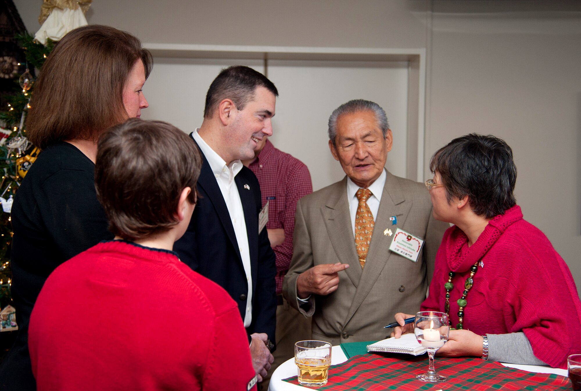 YOKOTA AIR BASE, Japan -- Kouemon Ishizuka, Mizuho Town mayor, speaks with Col. Mark August, 374th Airlift Wing commander, during August's bilateral holiday celebration at Yokota Air Base, Japan, on Dec. 1, 2012. Several Japanese dignitaries including civilian and military officials attended the event to experience American holiday tradition. (U.S. Air Force photo by Senior Airman Cody Ramirez)