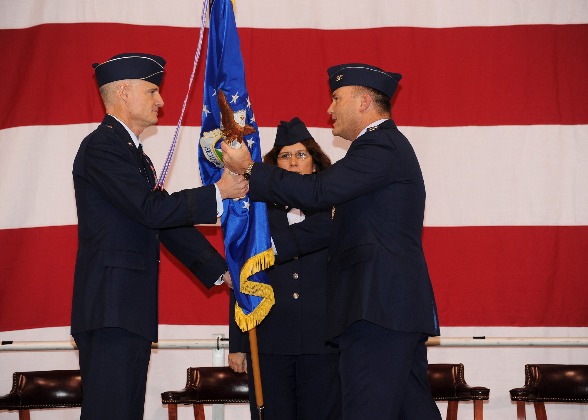 Oregon Air National Guard Col. Michael E. Stencel, 142nd Fighter Wing Commander passes the guidon to Brig. Gen. Steven Gregg, Commander of the Oregon Air National Guard, during the 142nd Fighter Wing Change of Command ceremony, at the Portland Air National Guard Base in Portland, Ore., Dec. 2. (U.S. Air Force photo Tech. Sgt. Emily Thompson, 142nd Fighter Wing Public Affairs / Released.)