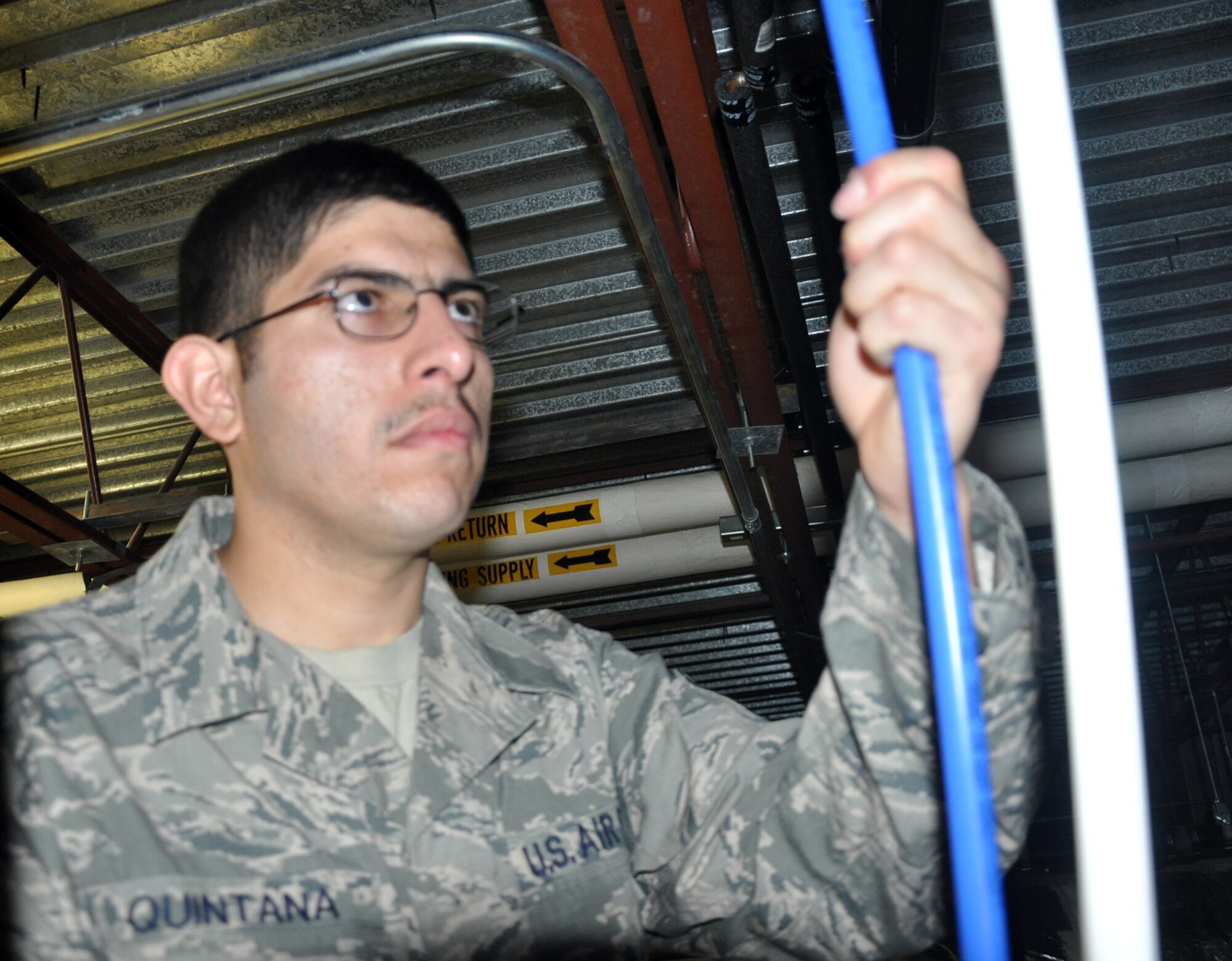 MCCHORD FIELD, Wash. - Tech. Sgt. Lazare Quintana, 446th CES utilities system assistant here, installs a water supply line at building 1216, Dec. 2.  Quintana is a plumber who was recently selected by the 313th Airlift Squadron for a position as a C-17 Globemaster III pilot.  The Reservist is planning to turn in his plumbing tools and head to Officer Training School in March 2013, then onto Flight School.  (U.S. Air Force photo by Tech. Sgt. Elizabeth Moody)