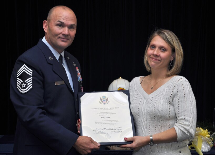 Chief Master Sgt. Cody Ellett, 442 Civil Engineer manager, presents his wife, Amy Ellett, with a certificate of appreciation at his retirement ceremony, Dec. 1. Ellett retired after many years of service to the Air Force. The 442nd CES is part of the 442nd Fighter Wing, an A-10 Thunderbolt II Air Force Reserve unit at Whiteman Air Force Base, Mo. (U.S. Air Force photo by Senior Airman Wesley Wright/Released)