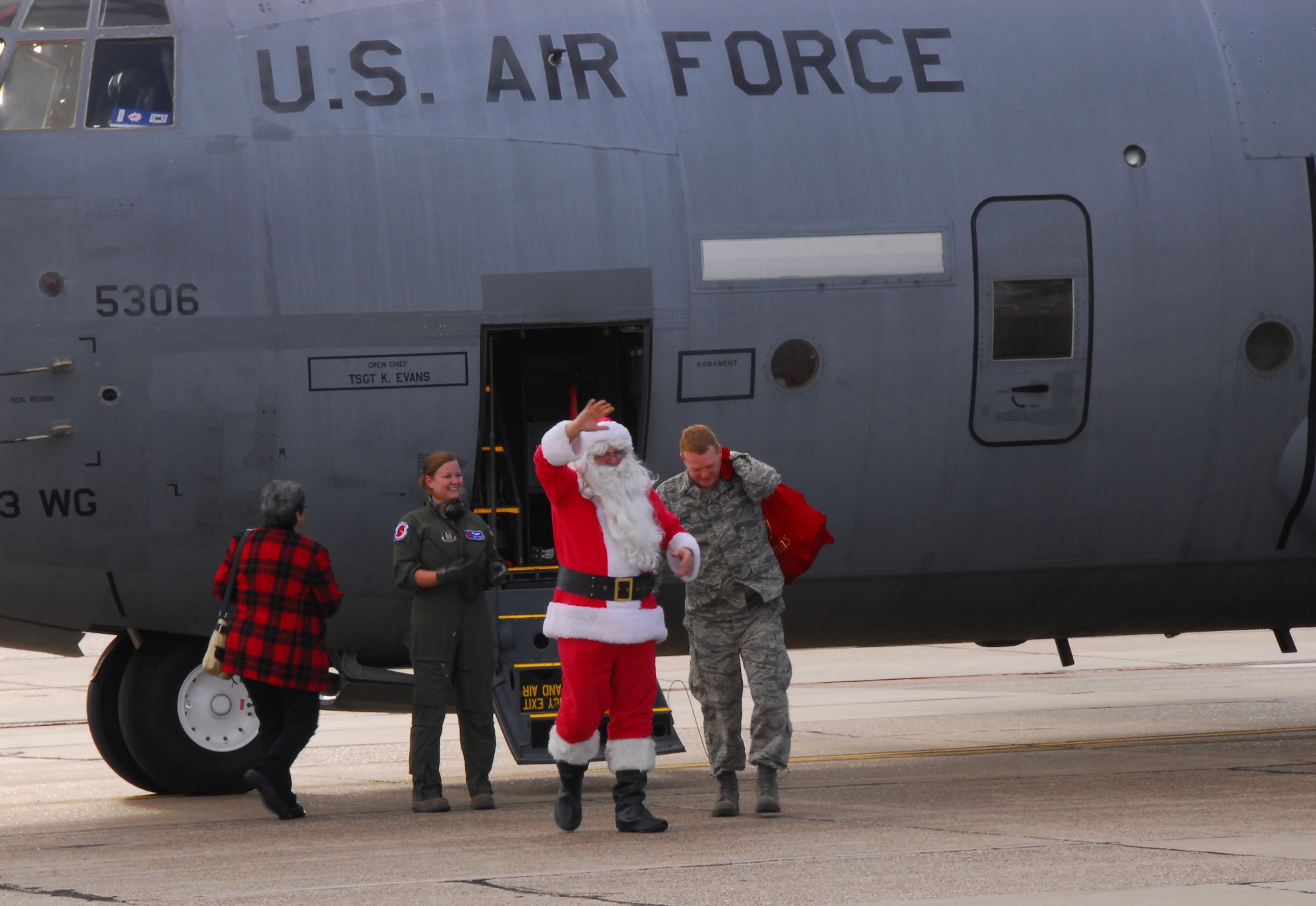 Santa Claus exits a 53rd Weather Reconnaissance Squadron WC-130J at the Roberts Maintenance Facility at Keesler Air Force Base, Miss., Dec. 1, 2012.  Santa Claus delivered presents to children of 403rd Wing servicemembers.  (U.S. Air Force Photo by Tech. Sgt. Jessica L. Kendziorek)
