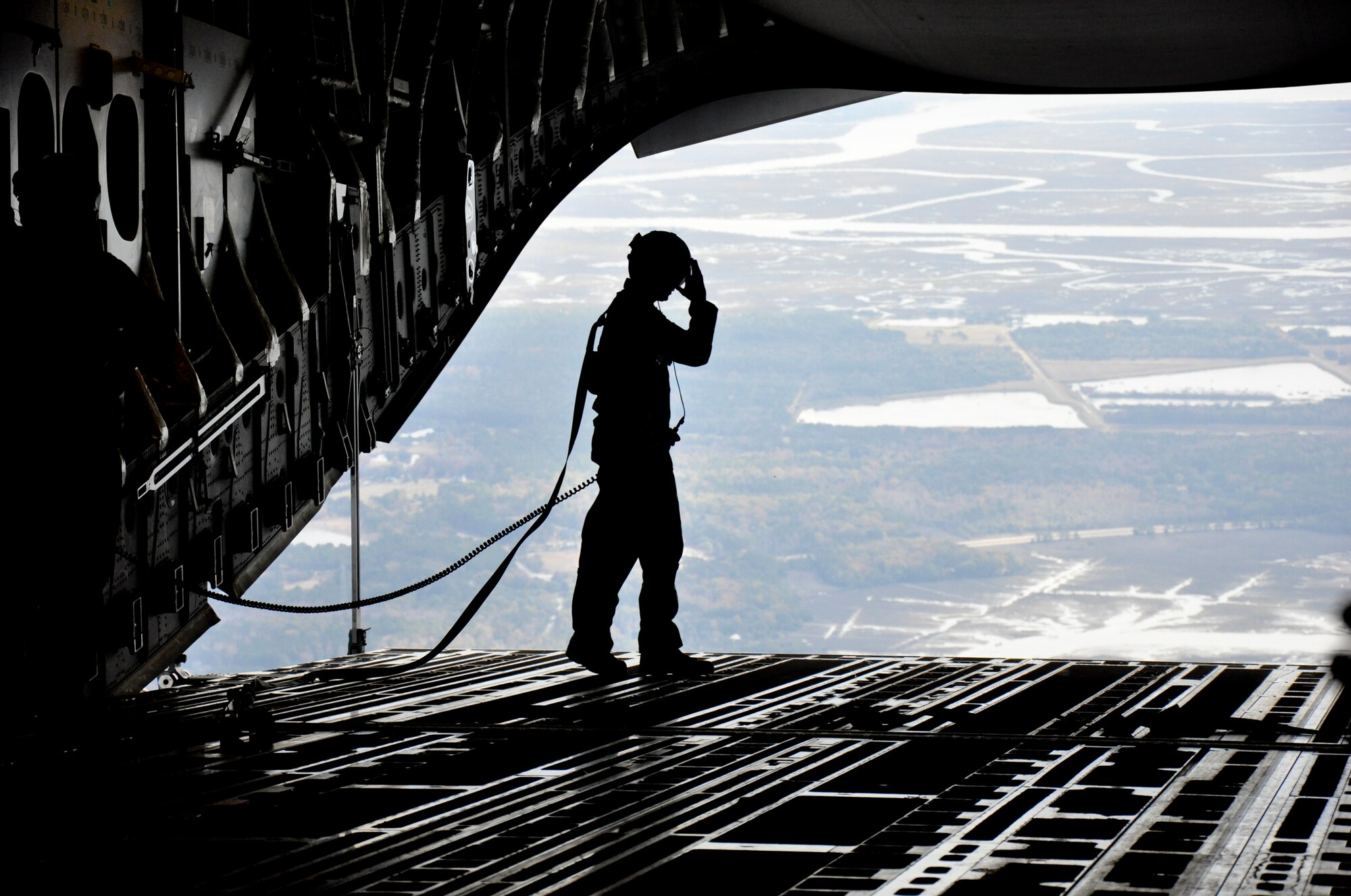 A 701st Airlfit Squadron loadmaster takes a view of the South Carolina landscape from the back of a C-17 Globemaster III here at Joint Base Charleston, S.C., during an employer/civic leader flight Saturday Dec. 1, 2012. (U.S. Air Force photo by Senior Airman  Bobby Pilch)
