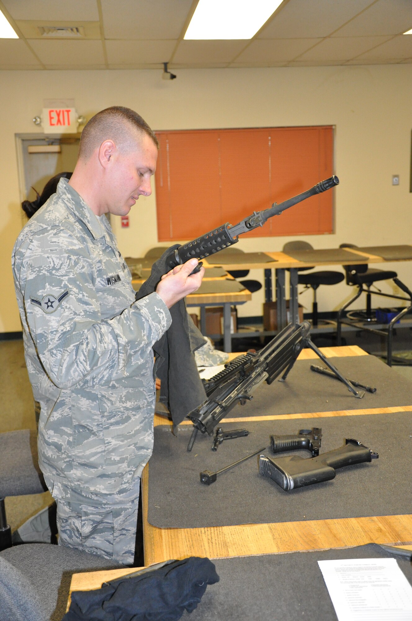 Airman Joseph Wismann of the 940th Security Forces Squadron wipes down the barrel of a disassembled M249 during instruction held on Saturday of the December Unit Training Assembly at Beale Air Force Base, Calif.  The 940th SFS held heavy weapons training during the UTA to keep their war fighters up to date on required weapons qualifications.  (U.S. Air Force photo/ Senior Airman Adam Hamar)