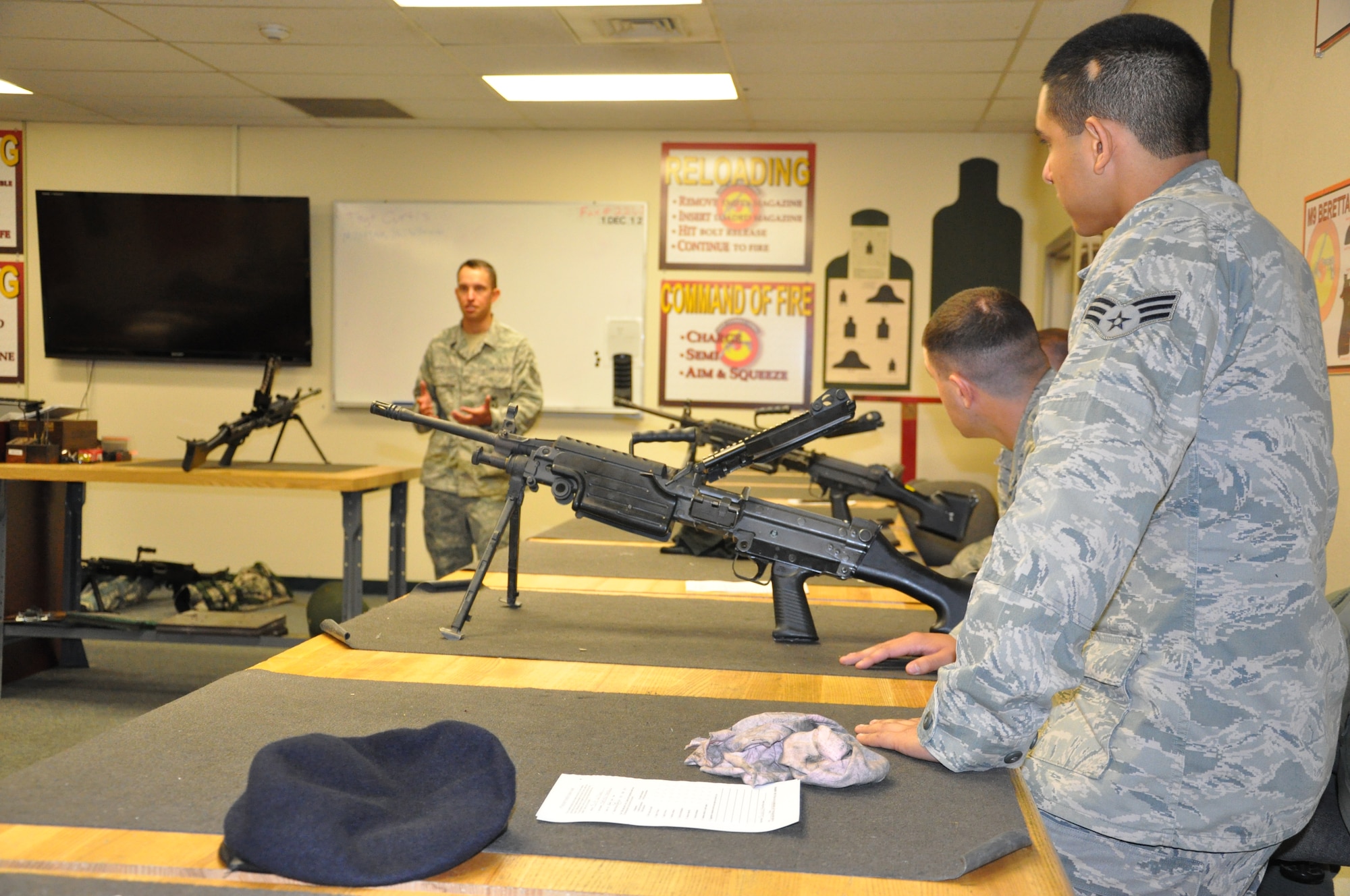Members of the 940th Security Forces look on as the instructor explains some of the differences between the M240 and M249 during instruction held on Saturday of the December Unit Training Assembly at Beale Air Force Base, Calif.  The 940th SFS held heavy weapons training during the UTA to keep their war fighters up to date on required weapons qualifications.  (U.S. Air Force photo/ Senior Airman Adam Hamar)