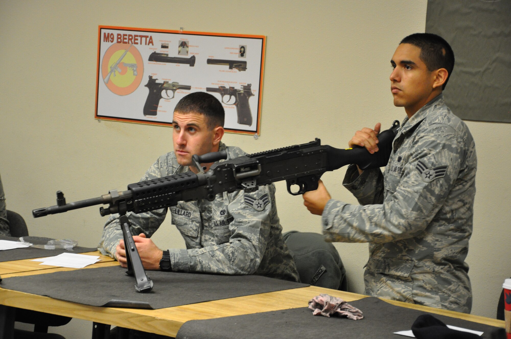 Members of the 940th Security Forces Squadron attentively look on as they are instructed on the proper way to handle the M240 on Saturday of the December Unit Training Assembly at Beale Air Force Base, Calif.  The 940th SFS held heavy weapons training during the UTA to keep their war fighters up to date on required weapons qualifications.  (U.S. Air Force photo/ Senior Airman Adam Hamar)