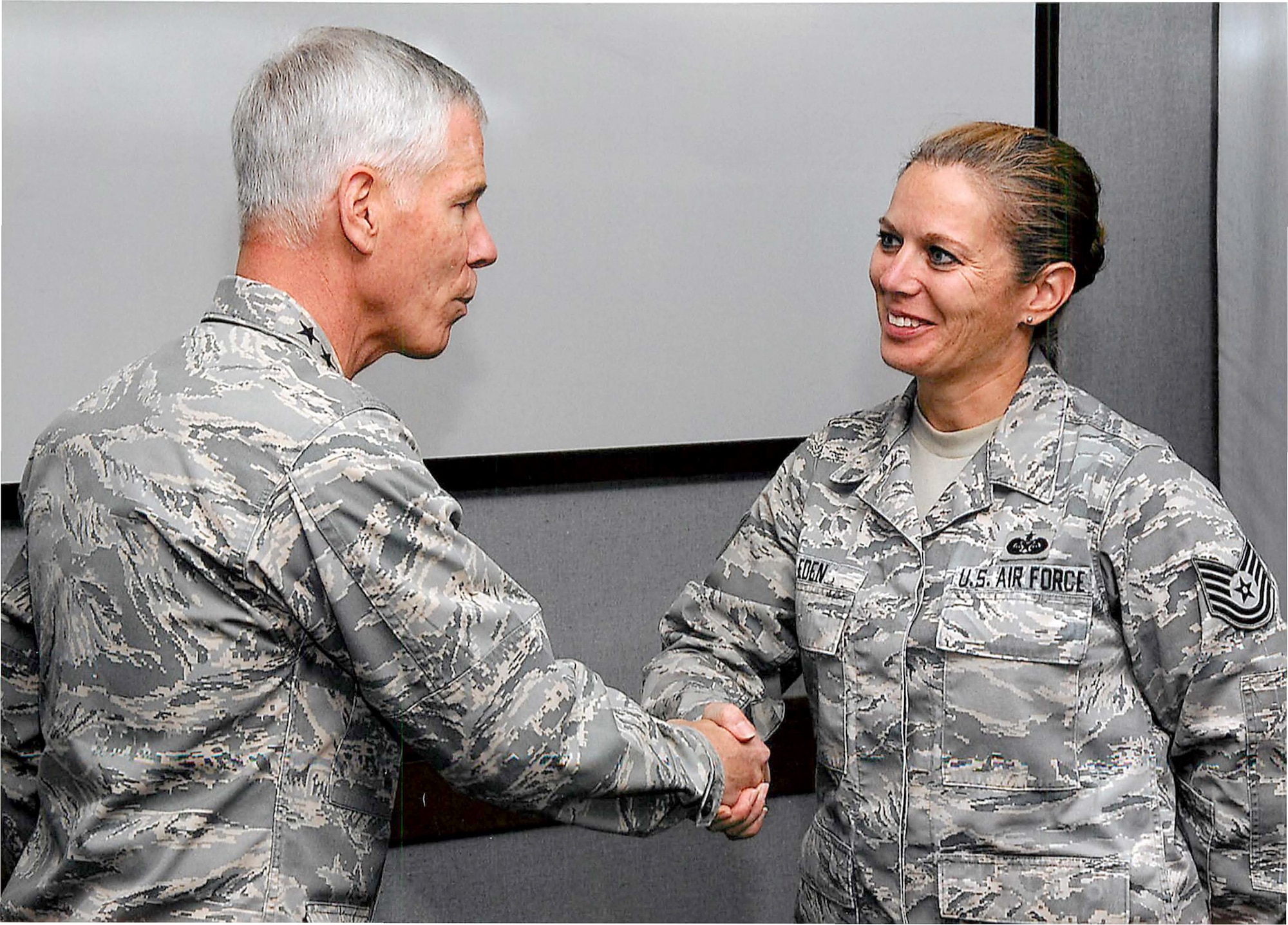 Gen. William Shelton, Commander, Air Force Space Command, congratulates and “coins” (then technical sergeant) Master Sgt. Sherrie Eden for her Recruiting Service accomplishments.  Eden, an Air Force Reserve line recruiter at the 302nd Airlift Wing at Peterson Air Force Base, Colo. tied for first place in a challenge issued by Shelton. The general asked recruiters to try to find placements for critically manned space operations positions. Eden who placed 48-percent of her recruits in space command during the challenge timeframe, was surprised by the honor. “I’m just focused on doing my job,” said Eden (Courtesy photo)