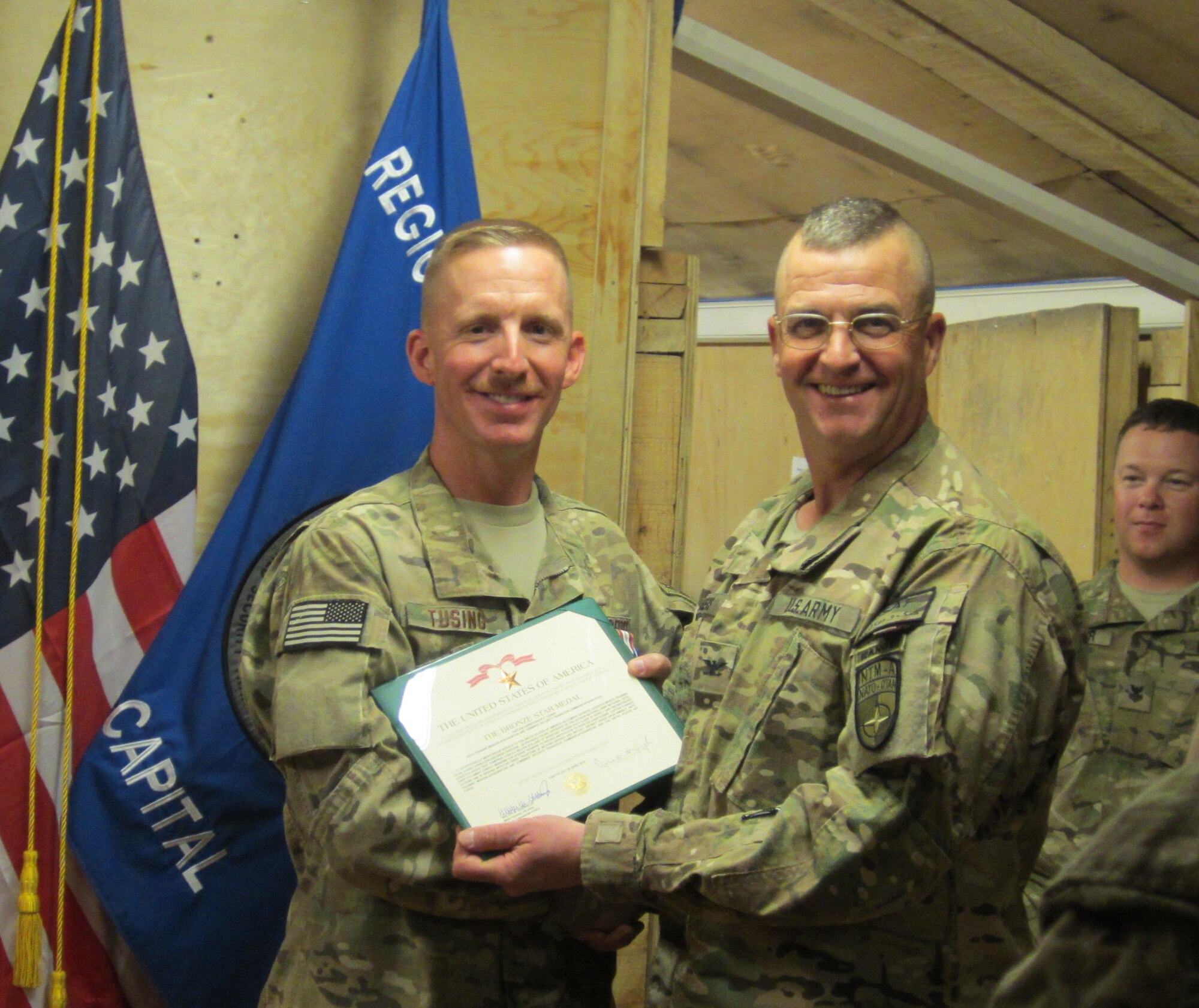 RSC-Capital Commander,  Col. Arthur G. Weeks, III, presented  Capt. Christopher T. Tusing with the Bronze Star Medal during his deployment to Afghanistan in 2012.
