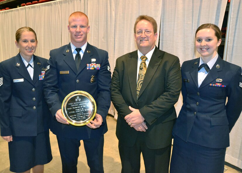 Tech. Sgt. Stefanie Linville, Senior Airman Gregory Haynes, St. Joseph Mayor Bill Falkner and Senior Airman Ryan Simbro present the Distinguished Citizen Award for Large Business of the Year Nov. 17 to the 139th Airlift Wing at the Mayor’s Thanksgiving Dinner in St. Joseph, MO. Col. Michael Pankau, Wing commander accepted the award, which was earned from the Wing’s outstanding community involvement and support. (U.S. Air Force courtesy photo) (Released)