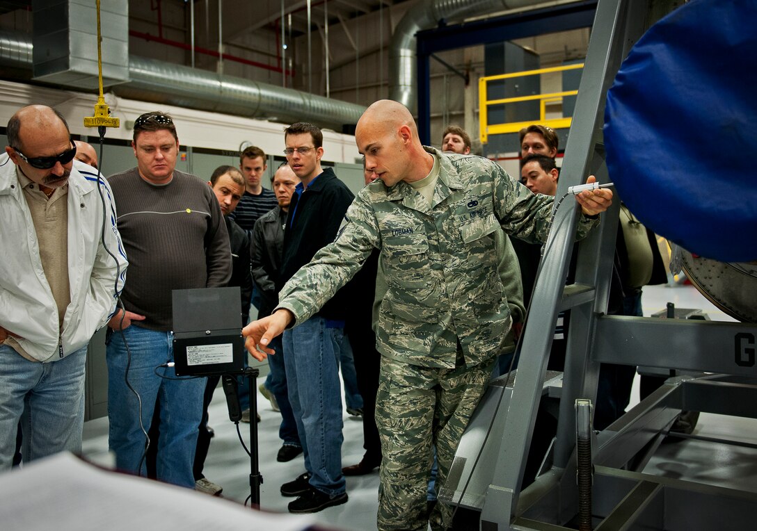 Master Sgt. Greg Lobman, of the 919th Maintenance Squadron, points to a display that shows the inner workings of a C-130 engine during an employer-day tour at Duke Field, Fla. Dec. 1.  More than 20 employers of 919th reservists attended the tour for a better understanding of how their workers contribute to the Air Force and special operations mission.  (U.S. Air Force photo/Tech. Sgt. Samuel King Jr.)