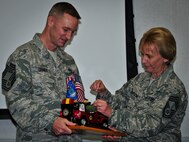 Chief Master Sgt. Michael Disney, of the 919th Civil Engineer Squadron, accepts the Jeep from Chief Master Sgt. Darlene Peterson as the newest chief during his induction ceremony at Duke Field, Fla. Dec. 1.  Following Air Force tradition, Disney must not relinquish control of the toy Jeep memento until the next new chief is inducted.  (U.S. Air Force photo/Tech. Sgt. Jon McCallum)