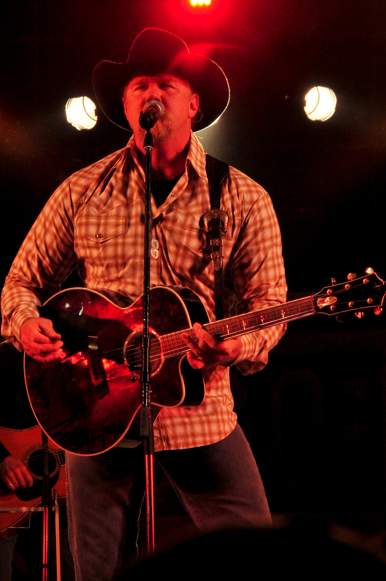 Country music artist, Trace Adkins performs for service members and their families at an 18th Force Support Squadron and USO-hosted concert in the Schilling community center parking lot on Kadena Air Base, Japan Dec. 1, 2012. The country music star performed a variety of songs and thanked the crowd for their service. (U.S. Air Force photo/Staff Sgt. Darnell T. Cannady)  