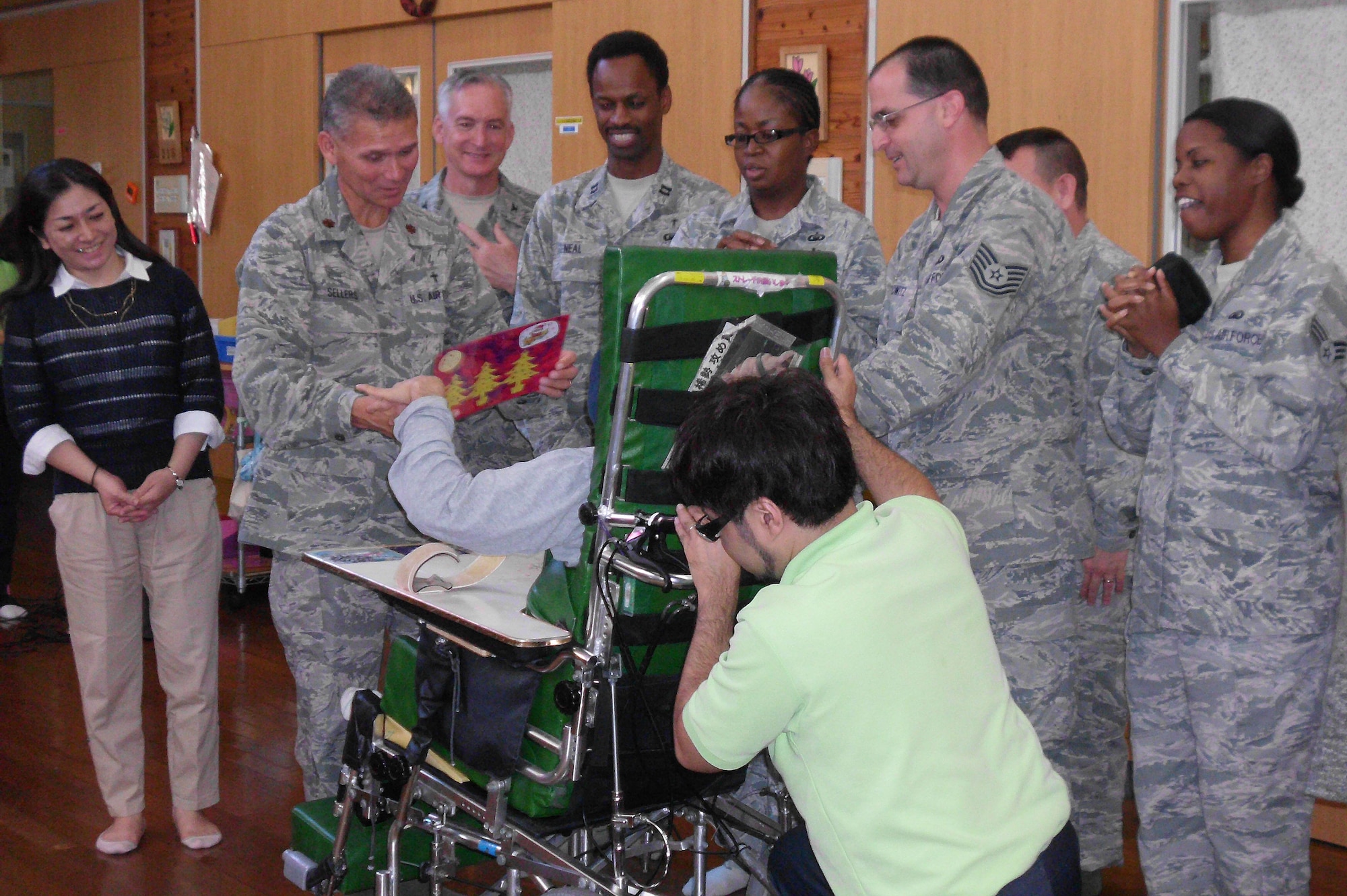 The 18th Wing chapel staff presents a donation from the Kadena Protestant Parish of more than $4,800 while visiting the Okinawa Disabled Children's Home in Owasso, Okinawa, Japan, Nov. 27, 2012. The Protestant Parish raised the money by collecting donations during three worship services on a Sunday from members across Okinawa to show the children and the community they cared. The children also prepared a Christmas card to present to the chaplains during their visit. (Courtesy Photo)