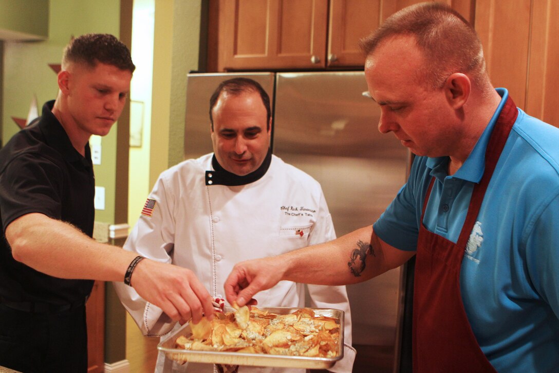 (Left to right) Sgt. Paul Dragicevich, Marine Corps Installations East - Marine Corps Base commanding general's aid, celebrity chef Rick Tarantino and Master Sgt. T.J. Hansen, II Marine Expeditionary Force commanding general's aid, get a taste of their freshly made potato chips during the II Marine Expeditionary Force Heroes Dinner aboard MCB Camp Lejeune, Nov. 14. Chef Rick and his team prepared a four-course dinner for the nine service members being honored for their heroic actions.