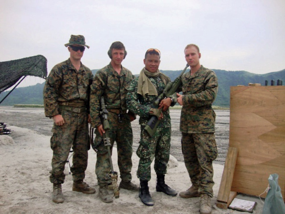 Cpl. Miles Cooley, chief sniper for the Scout Sniper Platoon, Headquarters & Service Company, Battalion Landing Team 2nd Battalion, 1st Marine Regiment, 31st Marine Expeditionary Unit (second left) stands with other Marines of the SSP and a Republic of the Philippines Marine sniper during training exercises of the Philippine Bilateral Landing Exercise.
