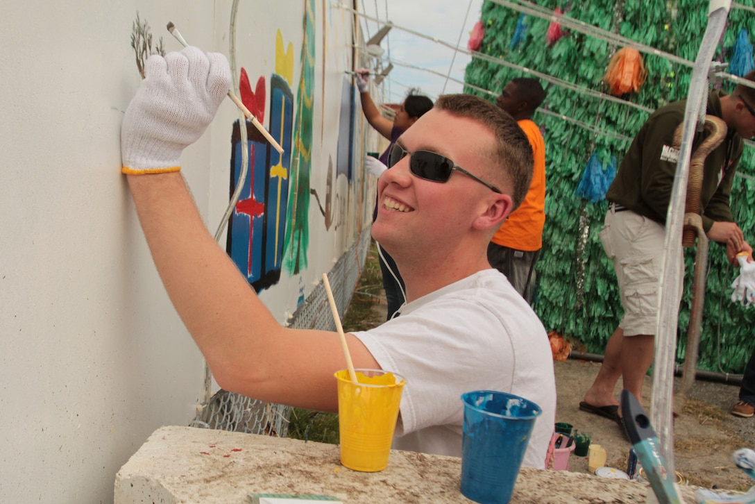 Lance Cpl. Austin Scott, a landing support specialist with Combat Logistics Battalion 31, 31st Marine Expeditionary Unit, and native of Wahoo, Neb., paints a Christmas mural during a town clean-up project here, Nov. 28. Marines and Sailors of CLB-31 painted a holiday message surrounded by depictions of Santa Claus and snow men outside the gates of Camp Hansen. The 31st MEU is the only continuously forward-deployed MEU and is the Marine Corps’ force in readiness in the Asia-Pacific region.