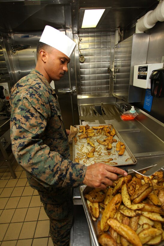 USS IWO JIMA, Mediterranean Sea (Nov. 29, 2012) - Lance Cpl. Elvis Fernandez, a Lisboa, Portugal, native with 24th Marine Expeditionary Unit, prepares food aboard USS Iwo Jima, Nov. 29, 2012. The 24th Marine Expeditionary Unit is deployed with the Iwo Jima Amphibious Ready Group in the 6th Fleet area of responsibility serving as an expeditionary crisis response force capable of a variety of missions, from full-scale combat to evacuations and humanitarian assistance. Since deploying in March, they have supported a variety of missions in the U.S. Central, Africa and European Commands, assisted the Navy in safeguarding sea lanes, and conducted various bilateral and unilateral training events in several countries in the Middle East and Africa. (U.S. Marine Corps photo by Lance Cpl. Tucker S. Wolf/Released) 