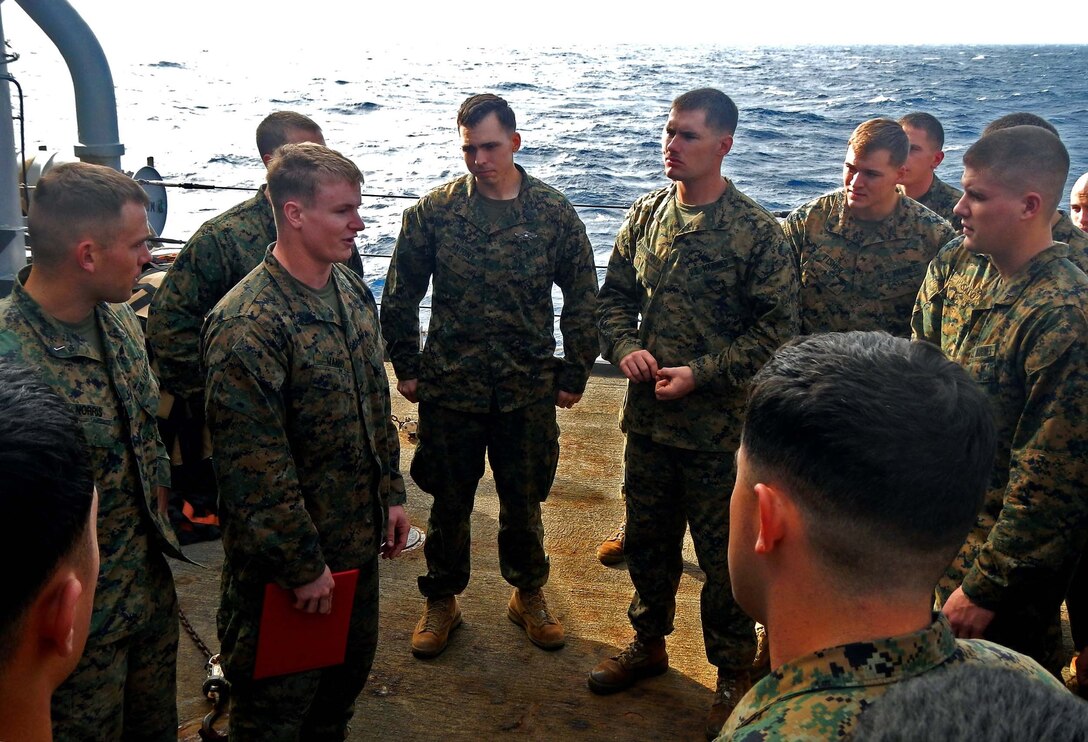 USS GUNSTON HALL, Mediterranean Sea - Cpl. Jesse Manno, a Branchvill, N.J., native with Charlie Co., Battalion Landing Team 1st Battalion, 2nd Marine Regiment, 24th Marine Expeditionary Unit, speaks to his platoon commander during his reenlistment ceremony on USS Gunston Hall, Nov. 30, 2012. The 24th Marine Expeditionary Unit is deployed with the Iwo Jima Amphibious Ready Group in the 6th Fleet area of responsibility serving as an expeditionary crisis response force capable of a variety of missions, from full-scale combat to evacuations and humanitarian assistance. Since deploying in March, they have supported a variety of missions in the U.S. Central, Africa and European Commands, assisted the Navy in safeguarding sea lanes, and conducted various bilateral and unilateral training events in several countries in the Middle East and Africa. (Photo courtesy of Cpl. Jesse Pehrson)