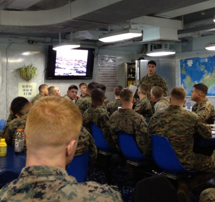 USS GUNSTON HALL, Mediterranean Sea - Cpl. Julian Valdez, squad leader for 2nd Platoon, Charlie Company, Battalion Landing Team 1st Battalion, 2nd Marine Regiment, 24th Marine Expeditionary Unit, presents a class to the Marines of 2nd Platoon on the Pacific Island Hopping Campaign of WWII on the mess deck of USS Gunston Hall, Nov. 23, 2012.  Classes like these and other training events are a continuous for Marines while underway aboard the amphibious assault ships of the Iwo Jima Amphibious Ready Group. The 24th Marine Expeditionary Unit is deployed with the Iwo Jima Amphibious Ready Group in the 6th Fleet area of responsibility serving as an expeditionary crisis response force capable of a variety of missions, from full-scale combat to evacuations and humanitarian assistance. Since deploying in March, they have supported a variety of missions in the U.S. Central, Africa and European Commands, assisted the Navy in safeguarding sea lanes, and conducted various bilateral and unilateral training events in several countries in the Middle East and Africa. (Photo courtesy of Cpl. Jesse Pehrson)