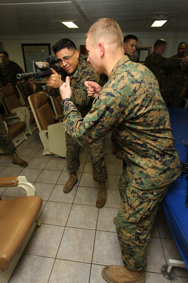 USS IWO JIMA, Mediterranean Sea (Nov. 30, 2012) - Staff Sgt. Aaron Davis(right), a Benton, Ark., native and Cpl. Michael Sanchez(left), a Lynn, Mass., native, both with the Command Element, 24th Marine Expeditionary Unit, practice the basic stance of shooting an M16A4 service rifle during a combat marksmanship class aboard USS Iwo Jima, Nov. 30, 2012. Combat marksmanship training is a continuous part of life for Marines, no matter what their military occupational specialty is, and regardless of whether they're stateside or deployed on a ship. The 24th Marine Expeditionary Unit is deployed with the Iwo Jima Amphibious Ready Group in the 6th Fleet area of responsibility serving as an expeditionary crisis response force capable of a variety of missions, from full-scale combat to evacuations and humanitarian assistance. Since deploying in March, they have supported a variety of missions in the U.S. Central, Africa and European Commands, assisted the Navy in safeguarding sea lanes, and conducted various bilateral and unilateral training events in several countries in the Middle East and Africa. (U.S. Marine Corps photo by Lance Cpl. Tucker S. Wolf/Released)