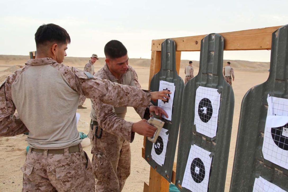 Lance Cpl. Syrus Isfahani, scout sniper, Scout Sniper Platoon, Weapons Company, Battalion Landing Team 3/5, 15th Marine Expeditionary Unit, staples a paper target at a marksmanship training event near Camp Buehring during Exercise Eager Mace 13, Nov. 12.  The U.S. Navy and Marine Corps participated in the bilateral training exercise with the Kuwait Armed Forces Nov. 11-21. The purpose of the exercise was to expand levels of cooperation, enhance mutual maritime capabilities, as well as promote long-term regional stability and interoperability between U.S. forces and regional partners. The 15th MEU is deployed as part of the Peleliu Amphibious Ready Group as a theater reserve and crisis response force throughout U.S. Central Command and the U.S. 5th Fleet area of responsibility.  (U.S. Marine Corps photo by Cpl. Timothy Childers/Released)