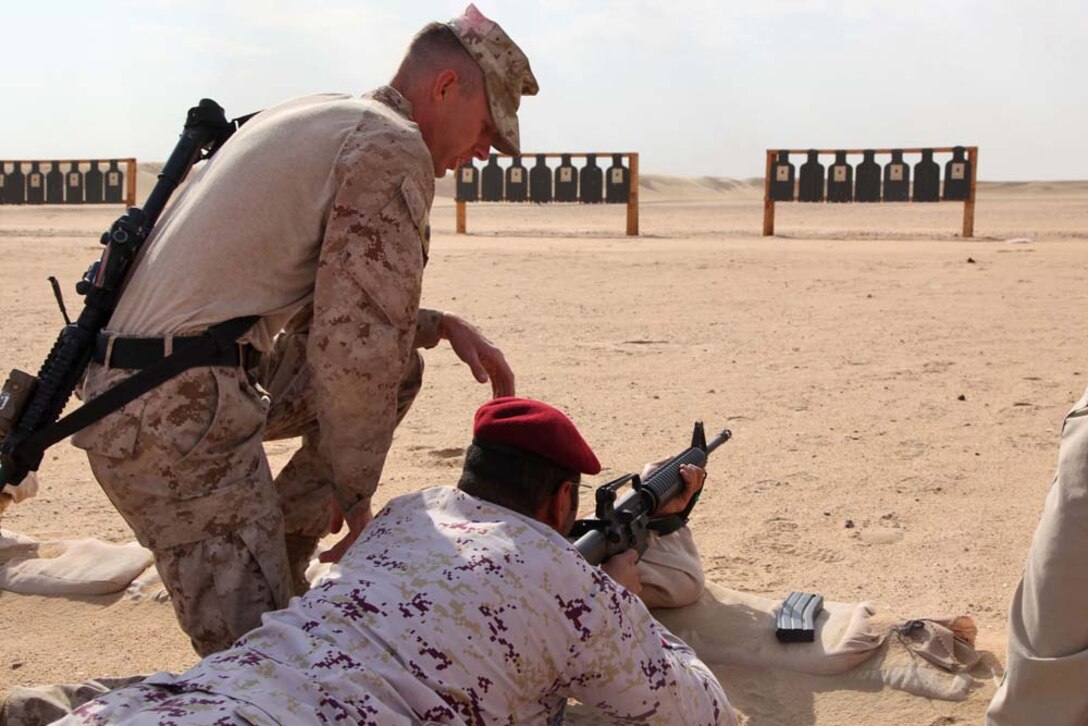 Staff Sgt. Nathan C. Stocking, platoon sergeant, Scout Sniper Platoon, Weapons Company, Battalion Landing Team 3/5, 15th Marine Expeditionary Unit, instructs members of the Kuwait Armed Forces in basic marksmanship techniques at a firing range near Camp Buehring during Exercise Eager Mace 13, Nov. 12. The U.S. Navy and Marine Corps participated in the bilateral training exercise with the Kuwait Armed Forces Nov. 11-21. The purpose of the exercise was to expand levels of cooperation, enhance mutual maritime capabilities, as well as promote long-term regional stability and interoperability between U.S. forces and regional partners. The 15th MEU is deployed as part of the Peleliu Amphibious Ready Group as a theater reserve and crisis response force throughout U.S. Central Command and the U.S. 5th Fleet area of responsibility. Stocking, 29, is from Phoenix, Ariz.  (U.S. Marine Corps photo by Cpl. Timothy Childers/Released)
