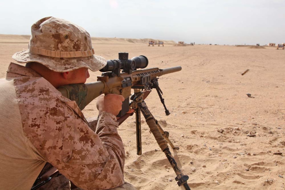 A U.S. Marine from Scout Sniper Platoon, Weapons Company, Battalion Landing Team 3/5, 15th Marine Expeditionary Unit, fires a semi-automatic sniper system at a marksmanship training event near Camp Buehring during Exercise Eager Mace 13, Nov. 12. The U.S. Navy and Marine Corps participated in the bilateral training exercise with the Kuwait Armed Forces Nov. 11-21. The purpose of the exercise was to expand levels of cooperation, enhance mutual maritime capabilities, as well as promote long-term regional stability and interoperability between U.S. forces and regional partners. The 15th MEU is deployed as part of the Peleliu Amphibious Ready Group as a theater reserve and crisis response force throughout U.S. Central Command and the U.S. 5th Fleet area of responsibility. (U.S. Marine Corps photo by Cpl. Timothy Childers/Released)
