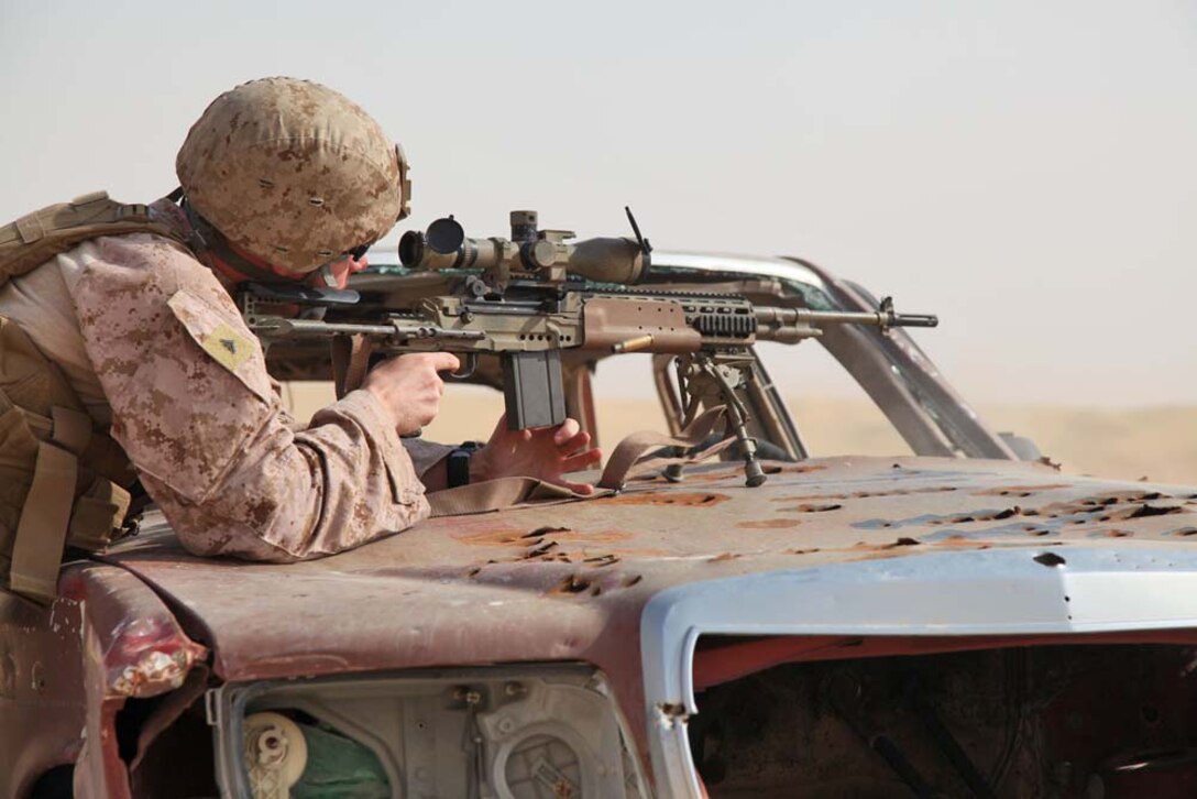 Lance Cpl. Matthew Long, scout sniper, Scout Sniper Platoon, Weapons Company, Battalion Landing Team 3/5, 15th Marine Expeditionary Unit, fires a M39 enhanced marksmanship rifle at a marksmanship training event near Camp Buehring during Exercise Eager Mace 13, Nov. 12. The U.S. Navy and Marine Corps participated in the bilateral training exercise with the Kuwait Armed Forces Nov. 11-21. The purpose of the exercise was to expand levels of cooperation, enhance mutual maritime capabilities, as well as promote long-term regional stability and interoperability between U.S. forces and regional partners. The 15th MEU is deployed as part of the Peleliu Amphibious Ready Group as a theater reserve and crisis response force throughout U.S. Central Command and the U.S. 5th Fleet area of responsibility. Long, 27, is from Kilgore, Texas. (U.S. Marine Corps photo by Cpl. Timothy Childers/Released)