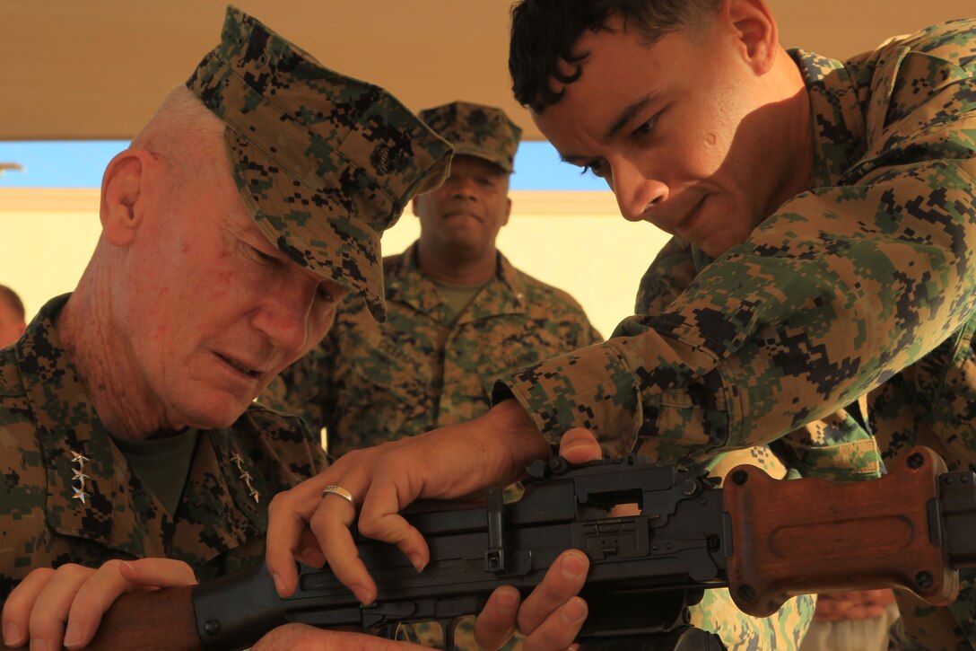 Lt. Gen. John A. Toolan, Jr., is shown a weapon demonstration by Sgt. Louis Diaz, advisor trainer, ATG, during his visit to the Combat Center’s ATG compound Nov. 16.