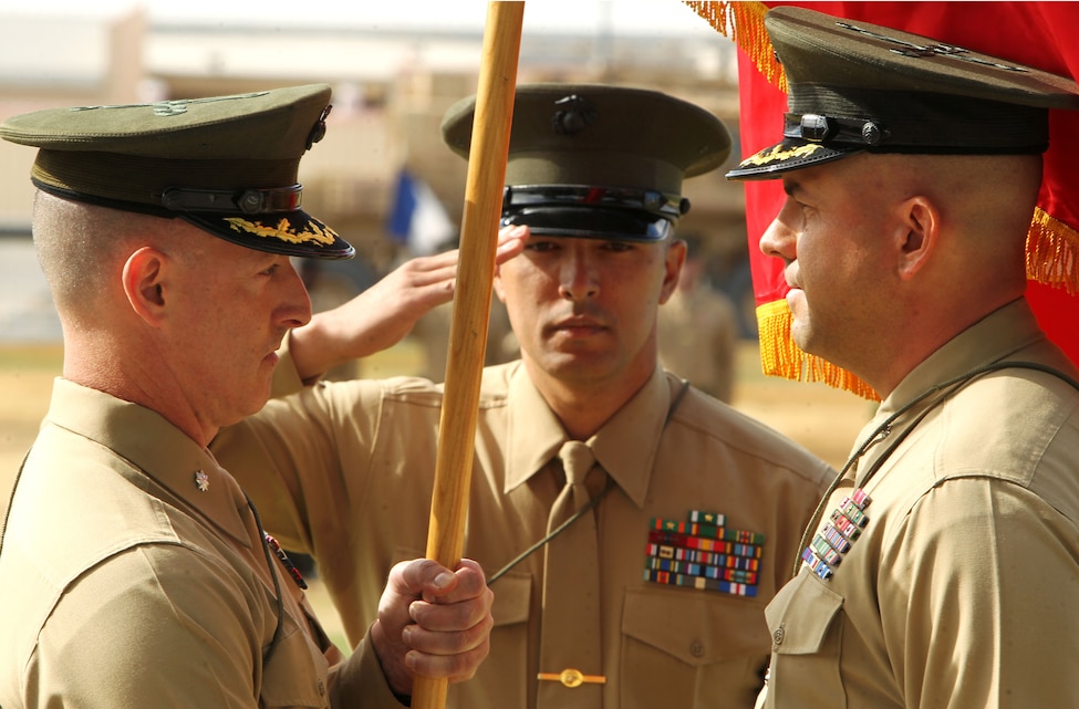 Lt. Col. Brian Dwyer  (left) receives command of 3rd Combat Engineer Battalion from Lt. Col. John Sullivan (right) during the unit's change of command ceremony at Lance Cpl. Torrey L. Gray Field Nov. 16. Behind the ceremony stood three platoons of 3rd CEB Marines, waiting to welcome their new commander. 
