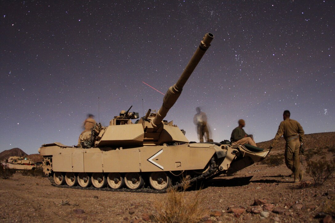 The crew of “That’s What She Said,” a tank with Company D, 1st Tank Battalion, talks before going to bed Oct. 25, 2009 at the Combat Center during the combined arms exercise known as Steel Knight.